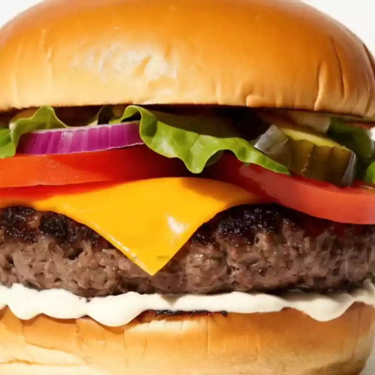 A hyperrealistic photo shows a cheeseburger being assembled with fresh lettuce, sliced tomato, red onion rings, cheddar cheese, pickles, a grilled beef patty, and mayonnaise on a soft bun, highlighting photorealistic digital art creation suitable for an ai product video maker or ai ad maker.