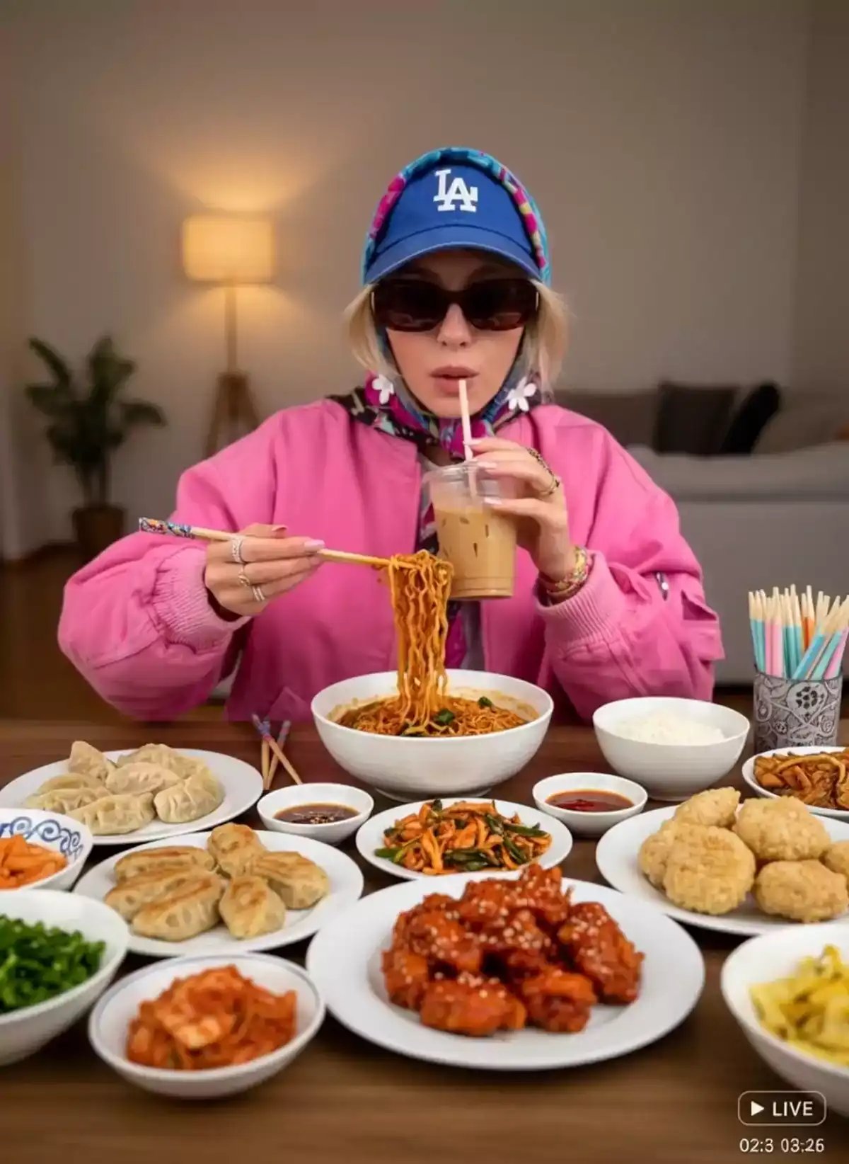 A woman wearing sunglasses and a colorful headscarf uses chopsticks to lift and eat spicy instant noodles from a bowl while holding a cup of iced coffee, depicted in a cinematic ai video style focused on hyperrealistic photo and ai video maker capabilities.