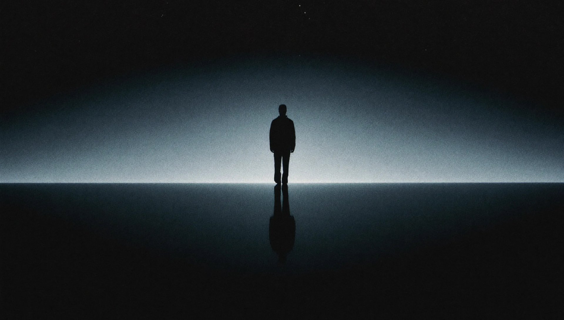 A silhouette reflected against a softly lit horizon.